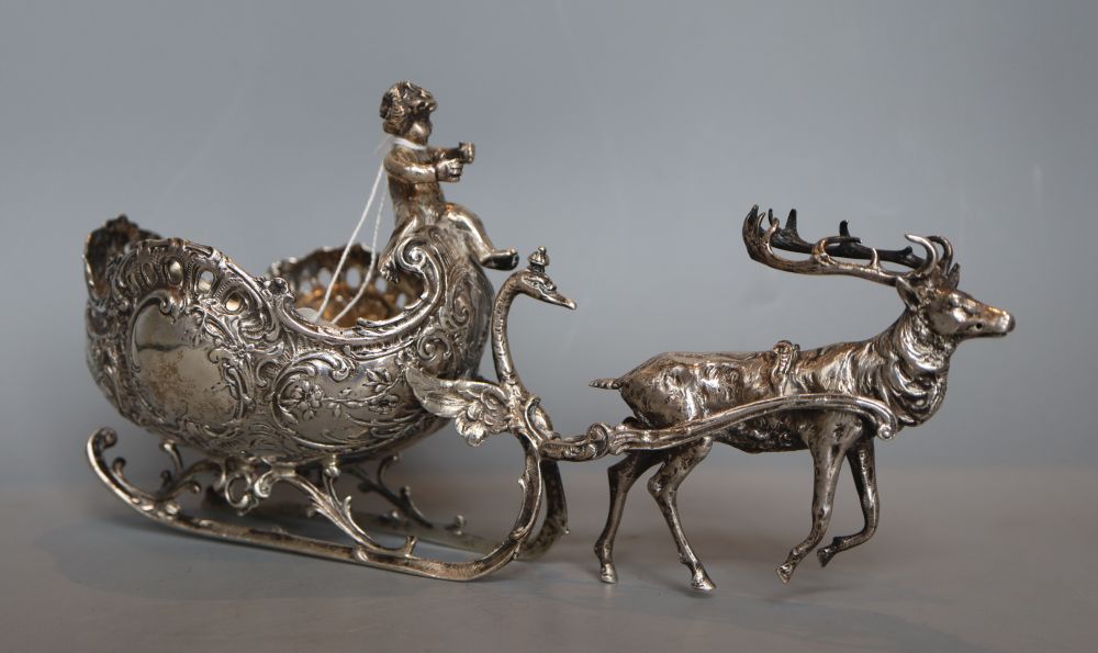 A late 19th century German silver bonbon dish, modelled as a reindeer pulling a sleigh with cherub